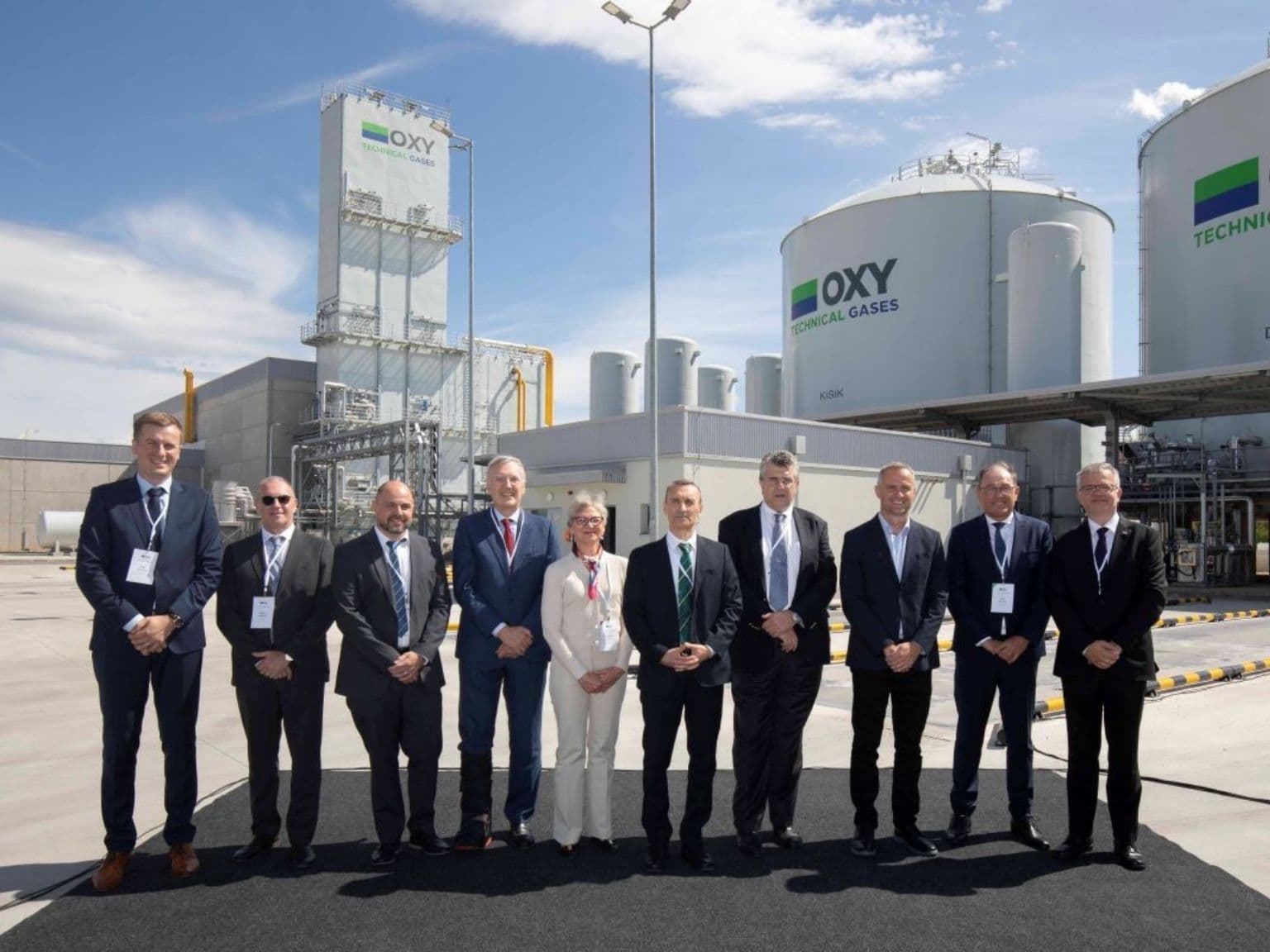 Group of executives standing at OXY Technical Gases plant during official opening ceremony